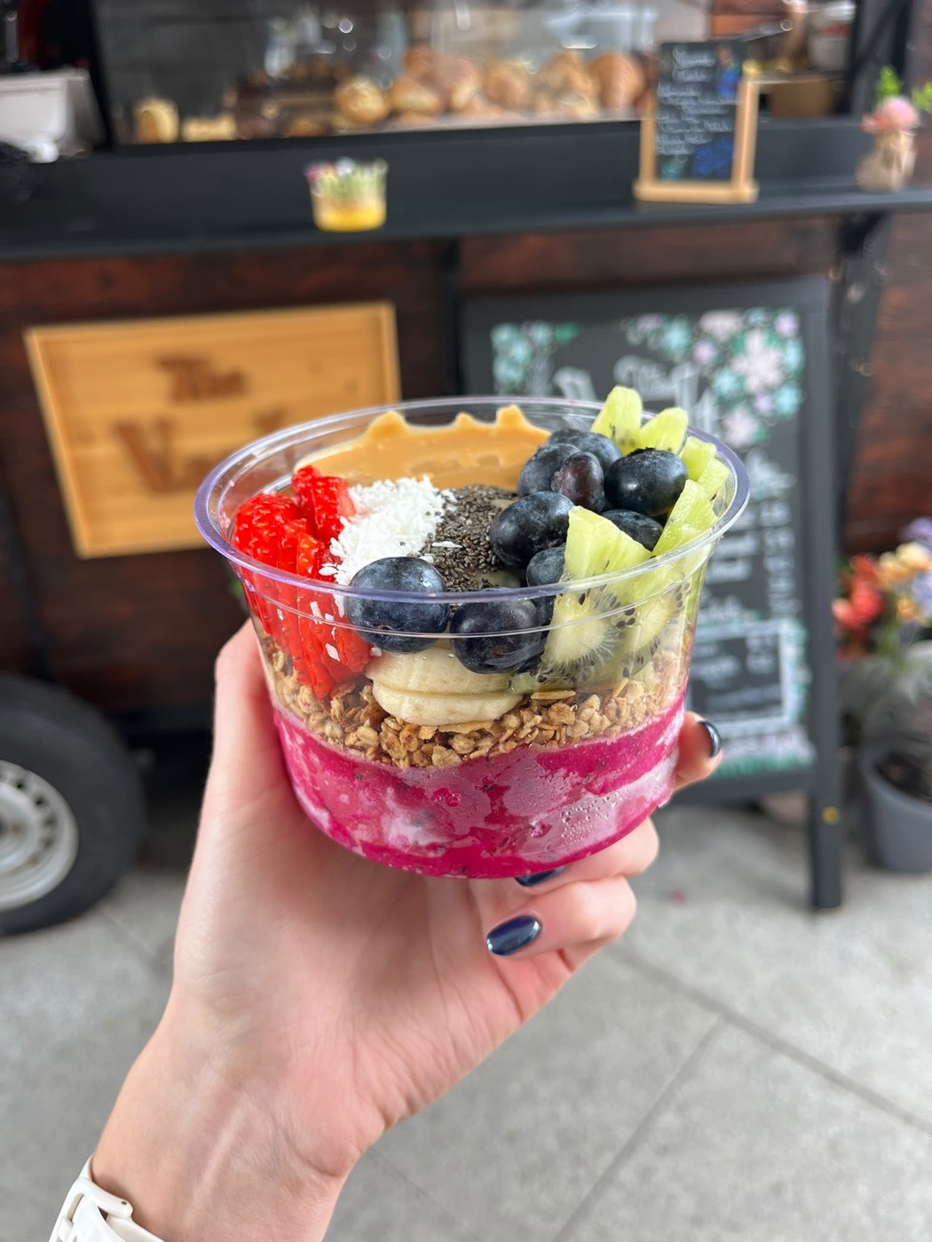 A dragonfruit açaí bowl in front of the Trailer